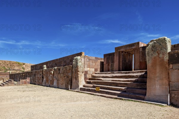 Broad view of ruins with stone entrances and stairs under clear skies, The archaeological site with