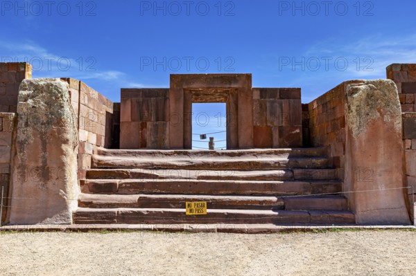 Stone architecture with stairs and entrance surrounded by ruins under blue skies, The