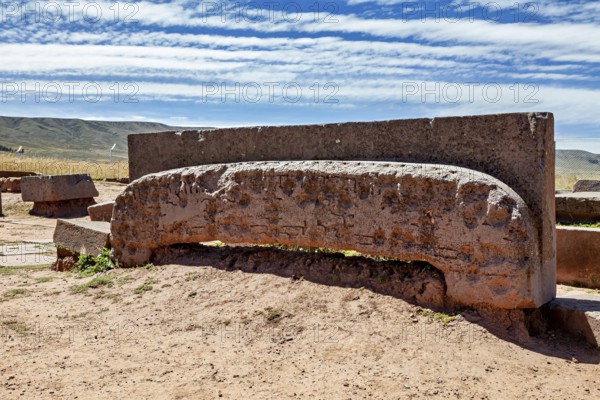 Ancient stone monument with mysterious engravings, lying under a cloudy sky in quiet surroundings,