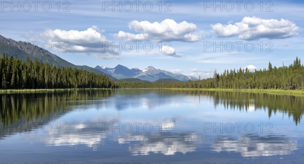 Mountains are reflected in idyllic Crystal Lake, McCarthy Highway, Wrangell St. Elias National