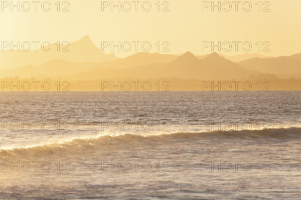 Evening light at Cape Byron with view to Mount Warning and sunlit hinterland, New South Wales,