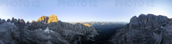 Aerial view, alpine panorama, Cima Tosa and rocky peaks at sunrise with alpine glow, picturesque