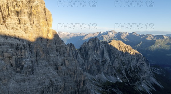 Aerial view, alpine panorama, rocky peaks at sunrise with alpine glow, picturesque mountain
