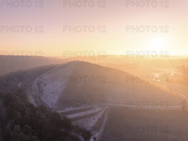 Natural hill in the soft light of a bright winter morning, old deposit, construction site for PV