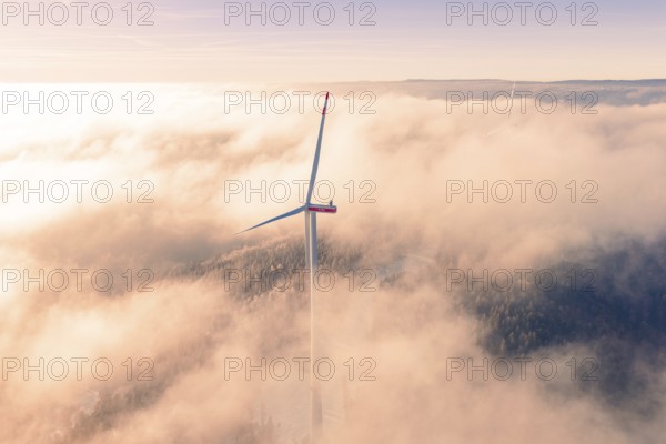 Wind turbine juts out of thick clouds, surrounded by foggy landscape, Bad Wildbad, Calw district,