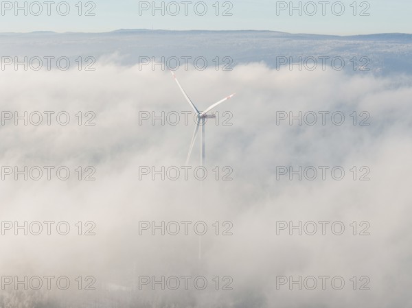 Blurred wind turbine hiding in thick clouds covered in fog, Bad Wildbad, Calw district, Black