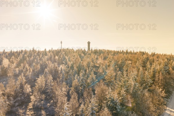 A bright winter sun over a snowy landscape with tower, Holohturm, Gernsbach, Rastatt district,