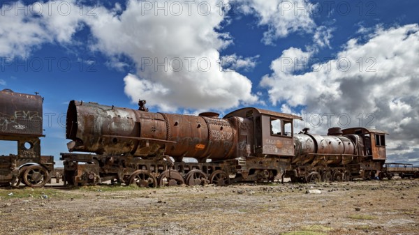 Abandoned, rusted locomotive in a dramatic cloudy landscape, old rusty locomotives at the train