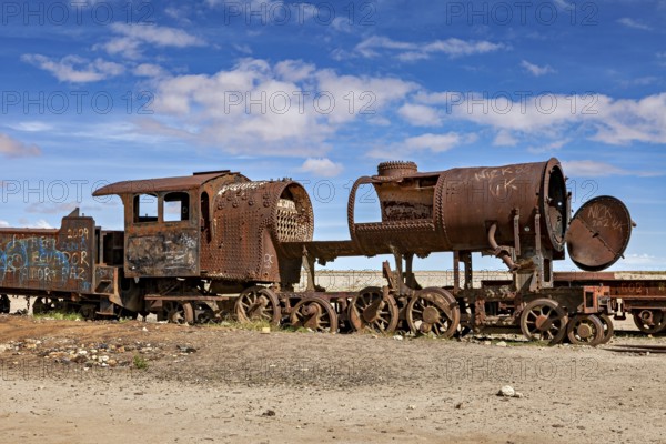 Rusty locomotive shows clear damage in an abandoned desert landscape, old rusty locomotives at the
