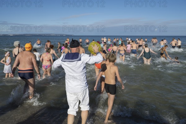 Swimmers run into water to bathe, tourist attraction Binzer Abbaden, Binz, seaside resort, Rügen