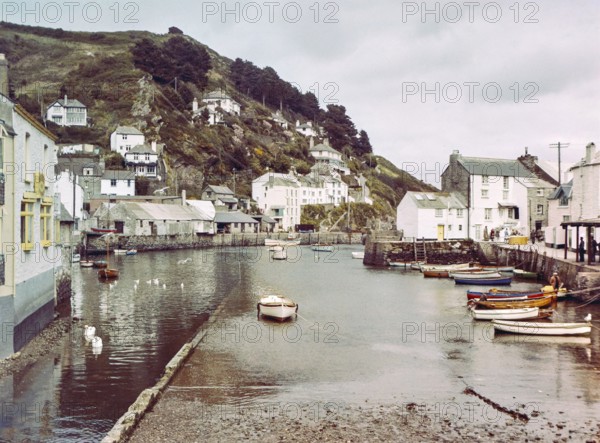 Historic waterfront buildings around the harbour river mouth of the River Pol at village of