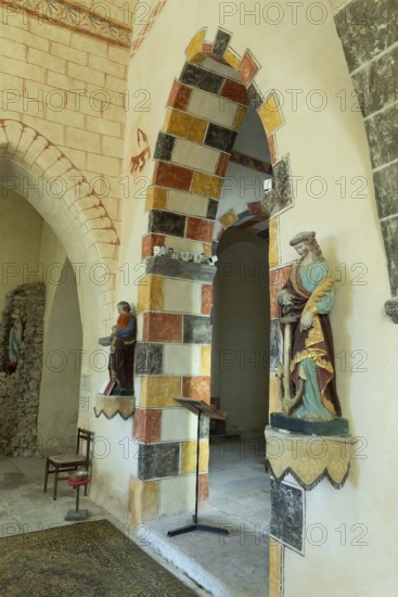 Painted arch in red, yellow and black. St Aignan's Church of Begues. Allier department. Auvergne