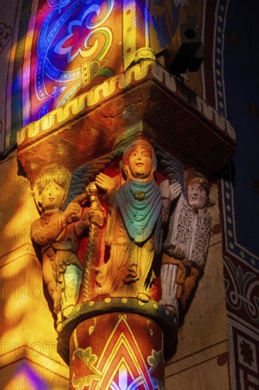 Issoire. Pillar (The Annunciation made to Mary) . The figures are illuminated by colorful light
