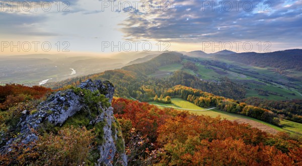 View from the Gisliflue of an autumn-colored forest, behind the Jurassic foothills with water fluh