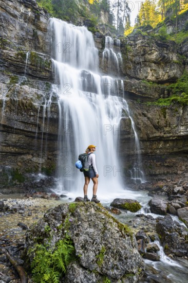 Young woman in front of Cascata di Mezzo waterfall, long exposure, Vallesinella, Brenta, Trentino,