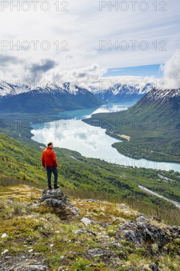 Climber enjoying the view, Slaughter Ridge Trail, view of snowy mountains and turquoise blue Kenai