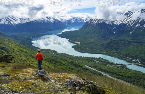 Climber enjoying the view, Slaughter Ridge Trail, view of snowy mountains and turquoise blue Kenai