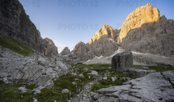 Picturesque mountain landscape in Val Brenta Alta at sunrise, rocky peaks of Cima Tosa,