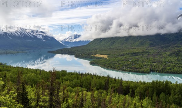View of snowy mountains in spring and turquoise blue Kenai Lake, Slaughter Ridge Trail, Cooper