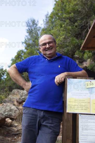 Corsican man, 67 years old, checks the entrance to the Genoese Tower of Porto, Ota, west coast of