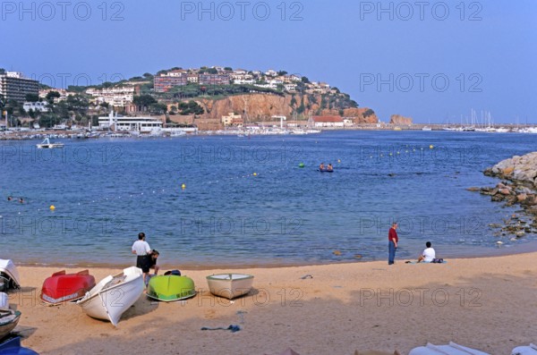 People, boats, Sant Feliu de Guixols beach on the Costa Brava, Spain, June 1999, vintage, retro,