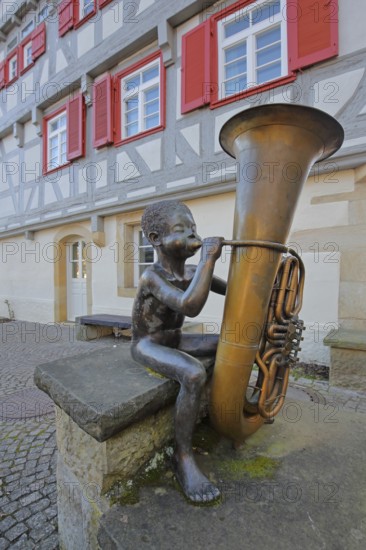 Sculpture boy with tuba by Guido Messer 1991, modern art, bronze sculpture, playing music, tuba,