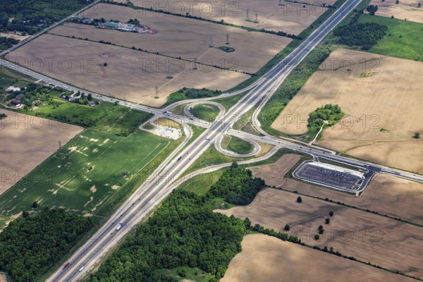 A large road junction surrounded by fields and green spaces, visible from the air, view from an
