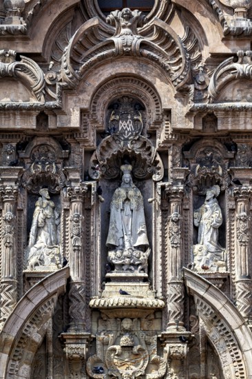 Ornate baroque façade with several statues and decorations, reliefs on the Basilica of St. Francis