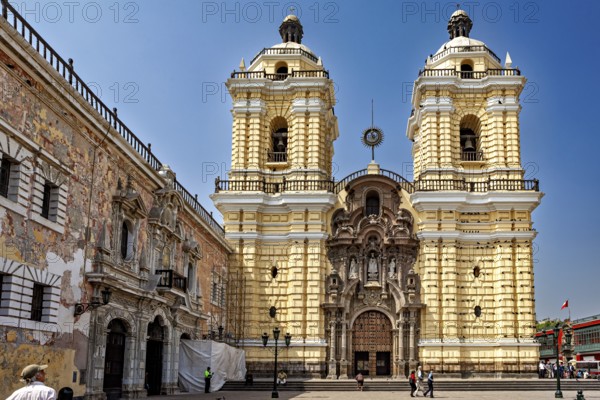 Baroque church with yellow façade and two towers in a sunny atmosphere, The Basilica of St. Francis