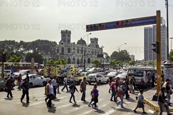 Urban street scene with pedestrians and traffic in front of historic buildings, Downtown Lima in