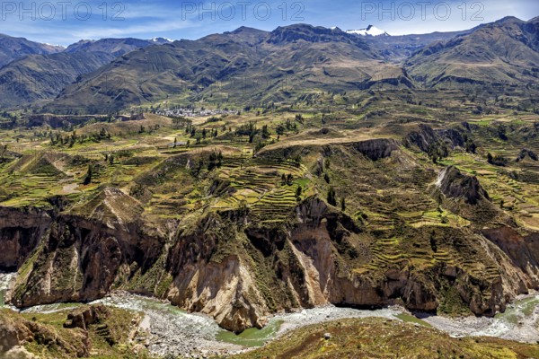 Mountain landscape with many terraces and a river under clear sky, The landscape of the Colca