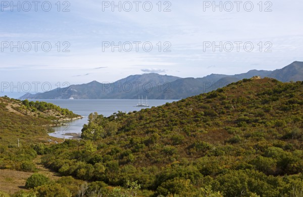 Sailing boat in the Mediterranean, Gulf of Saint-Florent, in front of the Agriates Desert or