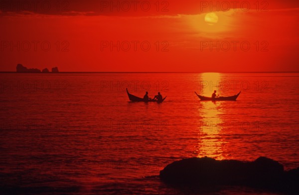 Fishing boats at sunset, silhouettes, orange filter, Ko Lanta island, Thailand, December 2002,