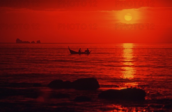 Fishing boat at sunset, silhouettes, orange filter, Ko Lanta island, Thailand, December 2002,