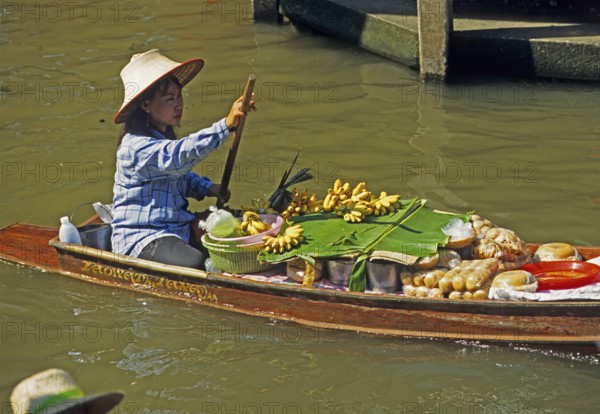 Merchant in her boat at Damnoen Saduak Floating Market, Thailand, December 2002, vintage, retro,