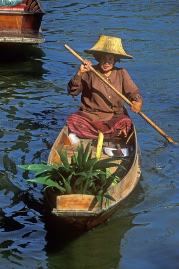 Merchant in her boat at Damnoen Saduak Floating Market, Thailand, December 2002, vintage, retro,
