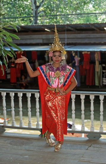 Young person wearing Thai drama clothes at Damnoen Saduak Floating Market, Thailand, December 2002,