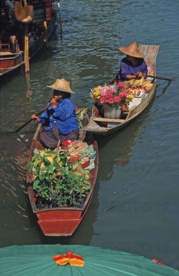 Merchants in their boats at Damnoen Saduak Floating Market, Thailand, December 2002, vintage,