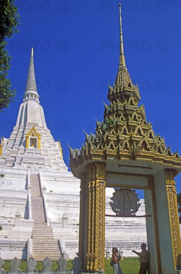 People, chedi, archway, white and gold temple Wat Phukao Thong, Ayutthaya, Thailand, December 2002,