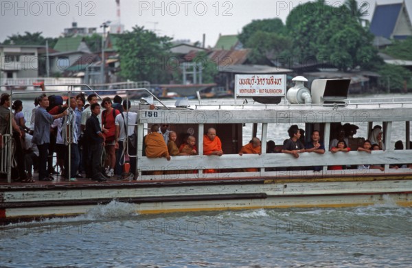 Liner on the Mae Nam Chao Phraya River, people, monks, children, Bangkok, Thailand, December 2002,