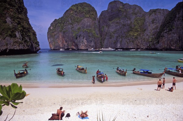 People, longtail boats on Maya Bay beach, known from the movie The Beach, one year in front of the
