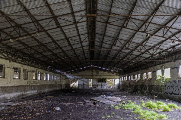 Abandoned hall with Grafity, dilapidated plant of a former agricultural production cooperative of