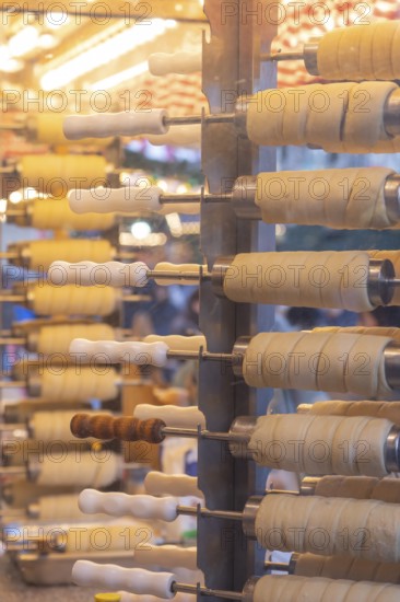 The trendy Chimney Cake stand at Stuttgart Christmas Market offers freshly baked, sweet treats. The