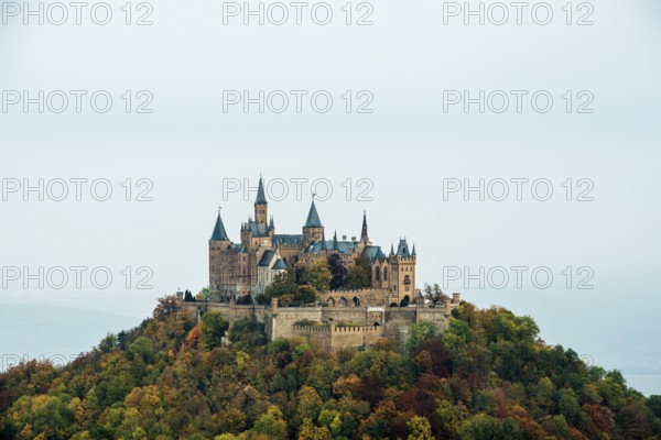 Castle and autumnal forest, Hohenzollern Castle, Hechingen, Swabian Jura, Baden-Württemberg,