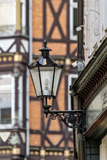 Nostalgic lantern in front of a half-timbered house with distinctive architectural patterns and