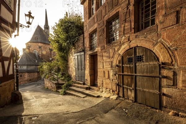 Romantic alleyway scene in the old town with sunlight, shadows and old architecture, The historic