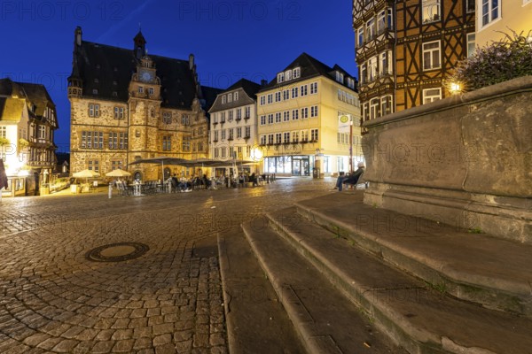 Square with historic flair, surrounded by half-timbered architecture, in the evening with paved