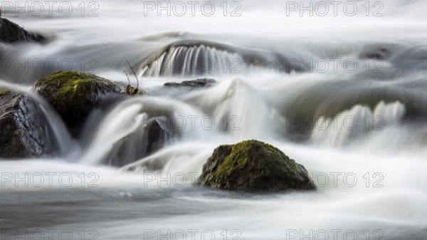 Running water over moss-covered stones in a quiet, natural environment, the small river Lahn flows