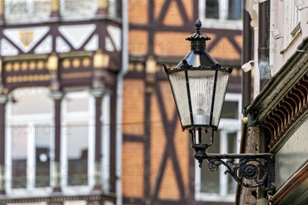 Nostalgic lantern in front of a half-timbered house with traditional architectural elements, The