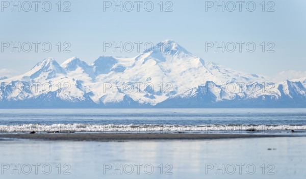 Beach at Anchor Point, Cook Inlet, glaciated mountain peaks of the Aleutian Range with Mount